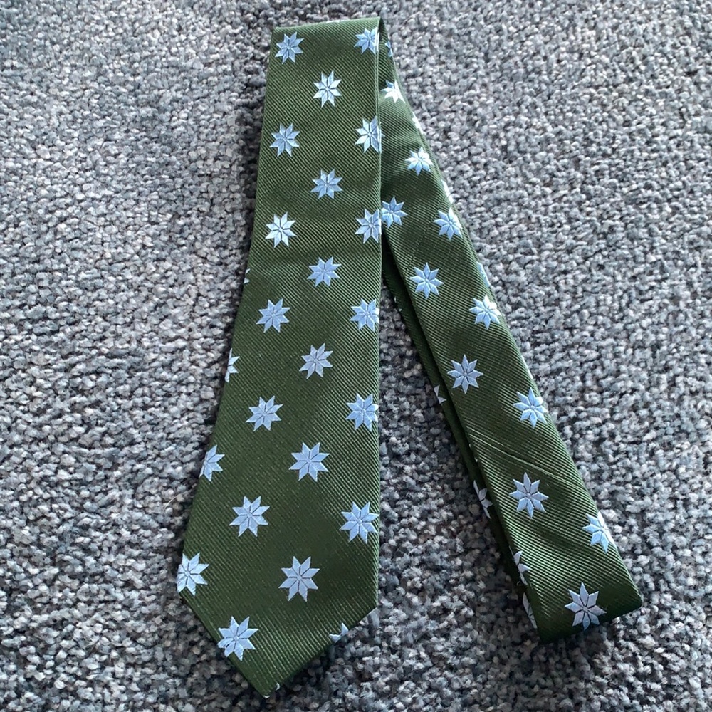 Sold.  Crewcuts forest green silk tie with blue stars
